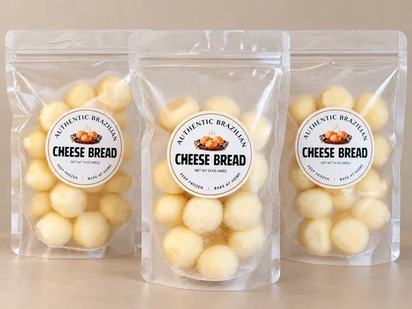 Three sealed transparent bags of frozen Original cheese bread